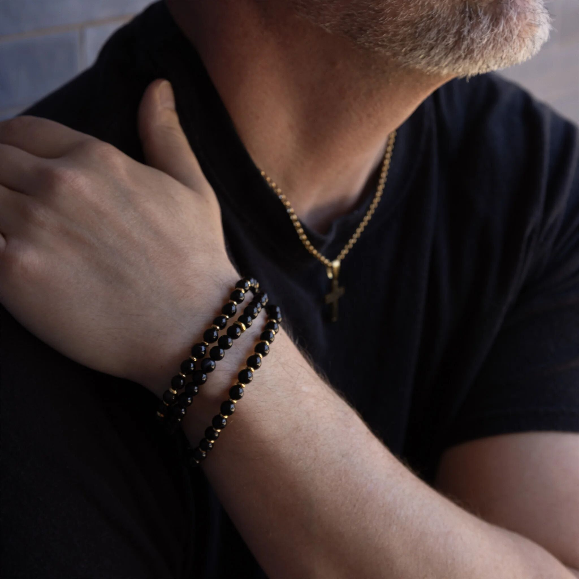 Men’s black beaded bracelet with gold accents