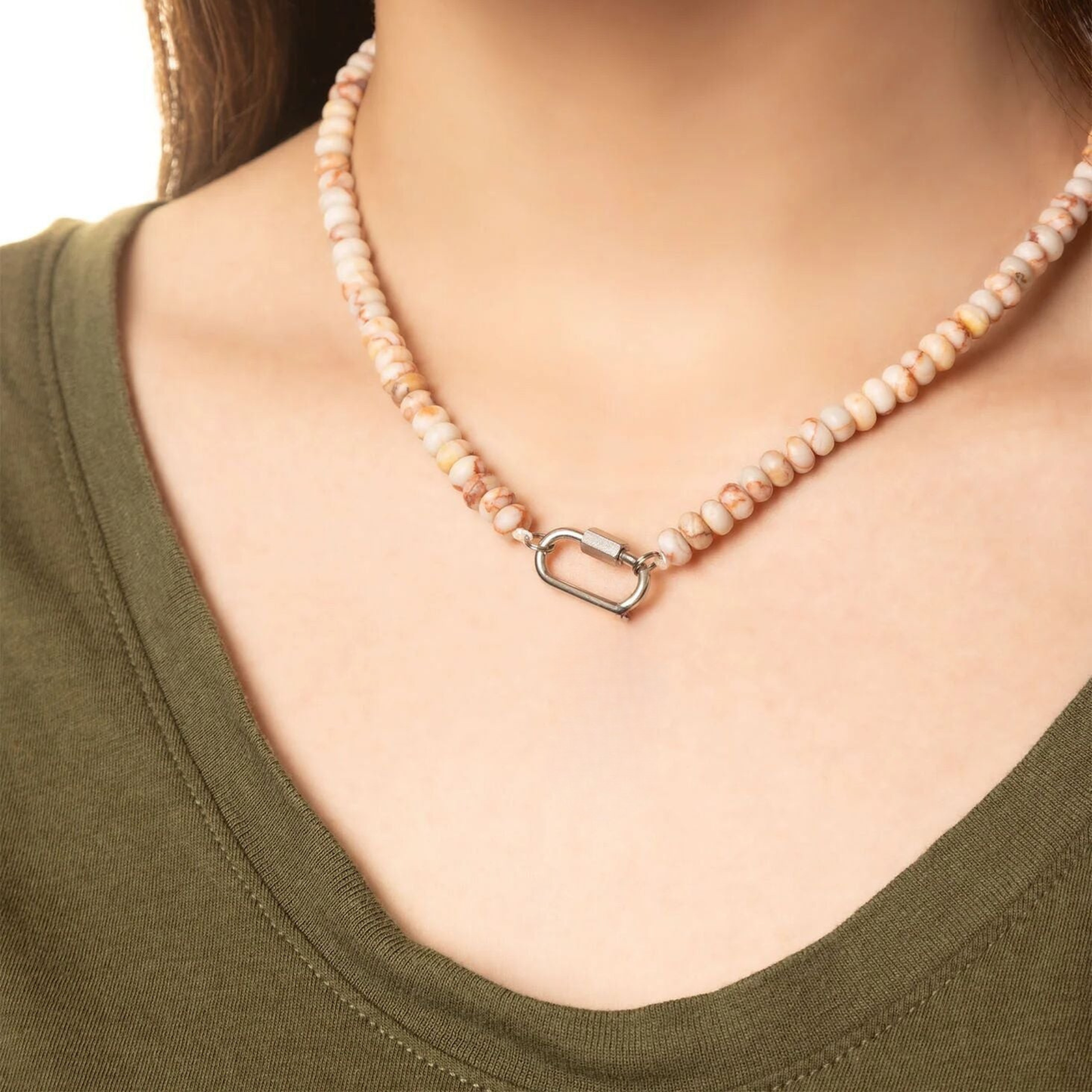 Close up of blush marble bead necklace with silver carabiner clasp on model