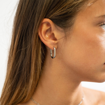 Woman wearing NEMOSN FormaLink Silver Oval Hoop Earrings