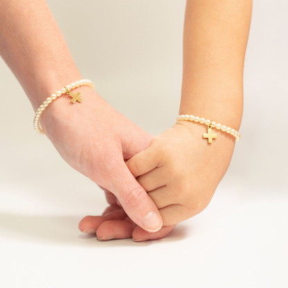 Mother and daughter wearing matching cross pearl bracelets by NEMOSN