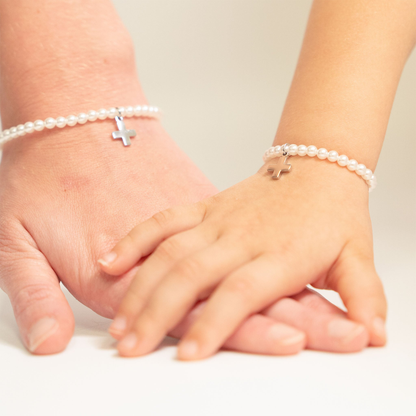 Mother and daughter wearing matching cross pearl bracelets by NEMOSN