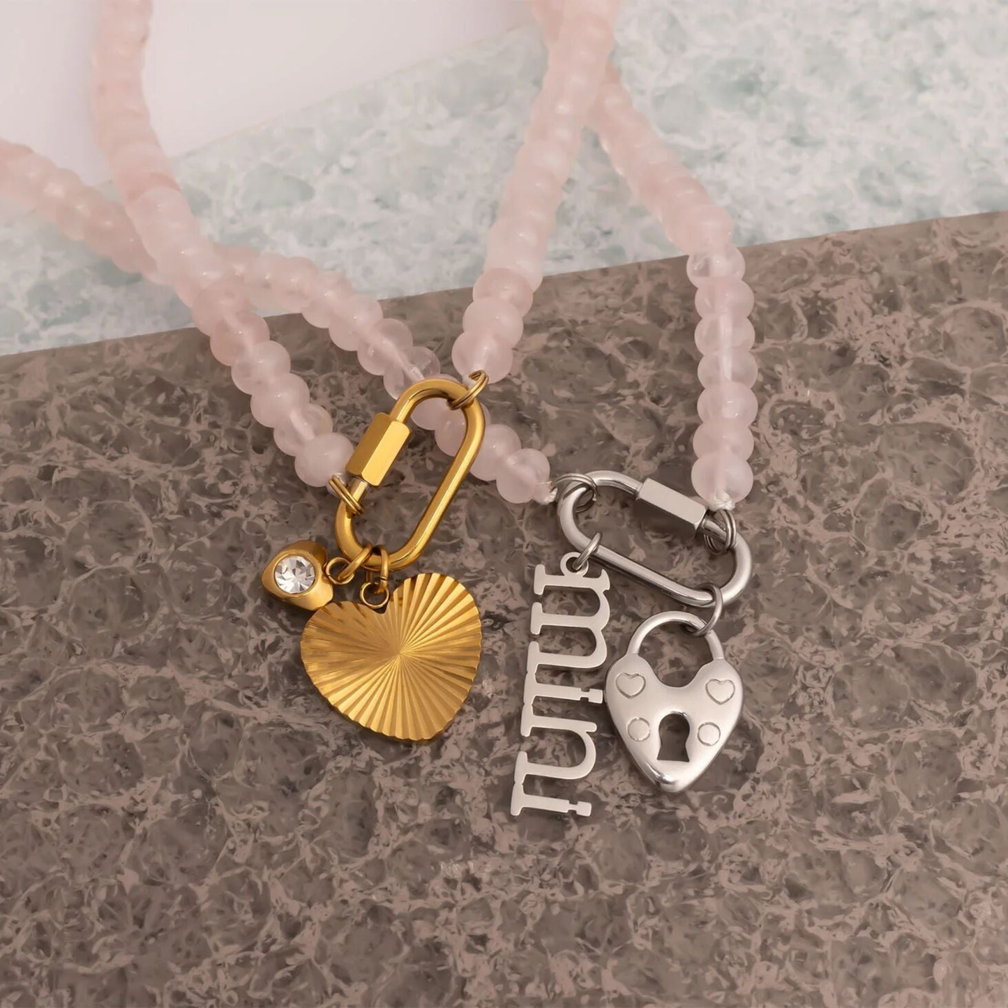 Rose quartz beaded necklace with gold clasp styled with removable charms